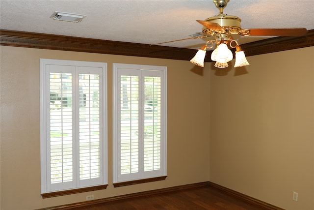 unfurnished room featuring a textured ceiling, crown molding, dark hardwood / wood-style floors, and ceiling fan