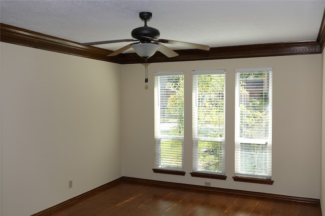 empty room with ornamental molding, dark wood-type flooring, ceiling fan, and a healthy amount of sunlight