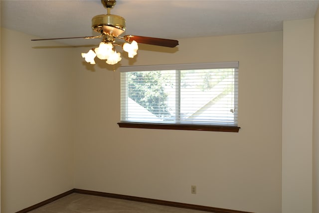 empty room with ceiling fan and a textured ceiling