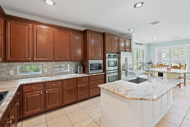 kitchen with crown molding, light stone counters, decorative backsplash, stainless steel appliances, and a sink