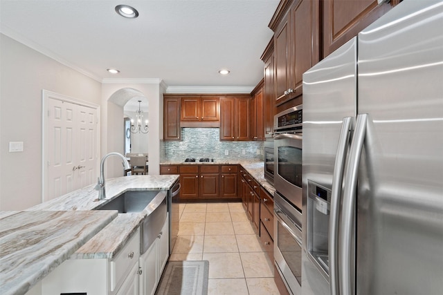 kitchen with light tile patterned floors, an inviting chandelier, arched walkways, stainless steel refrigerator with ice dispenser, and backsplash