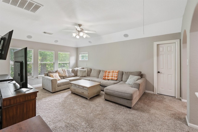 carpeted living room featuring visible vents, baseboards, and ceiling fan