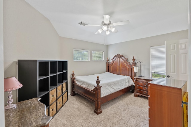 bedroom with visible vents, light carpet, lofted ceiling, and ceiling fan