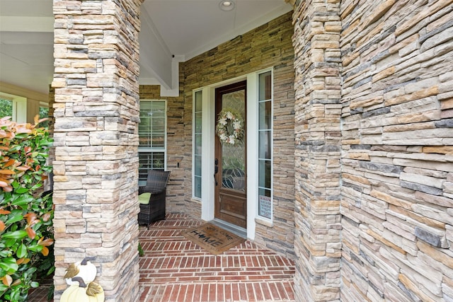 entrance to property featuring stone siding