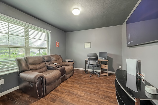 home office featuring wood-type flooring and a textured ceiling