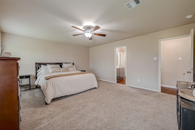 carpeted bedroom featuring ensuite bathroom and ceiling fan