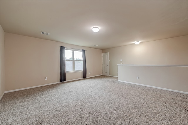 carpeted spare room with a water view