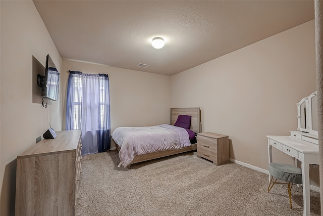 bedroom with carpet flooring and a textured ceiling