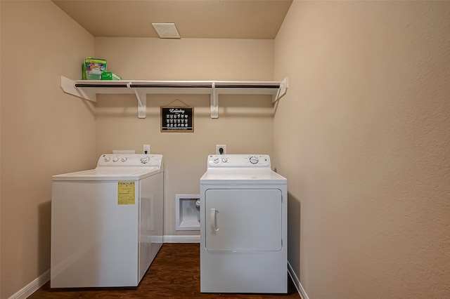 laundry room with washing machine and dryer and dark hardwood / wood-style floors