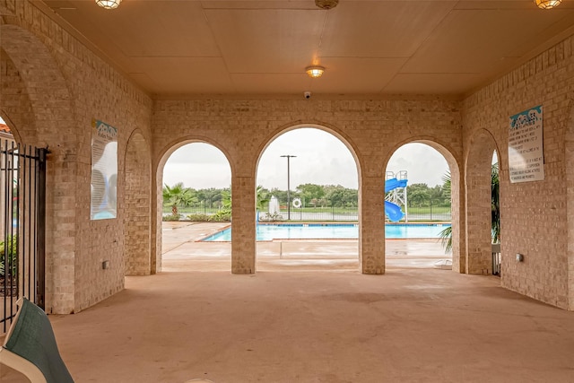 pool with a patio and a water slide