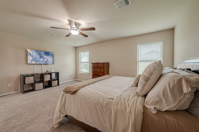 bedroom featuring multiple windows, carpet, and ceiling fan