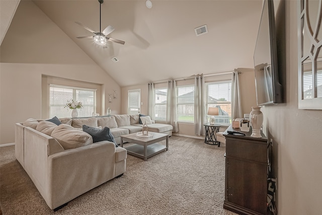 living room with a wealth of natural light, ceiling fan, high vaulted ceiling, and carpet floors