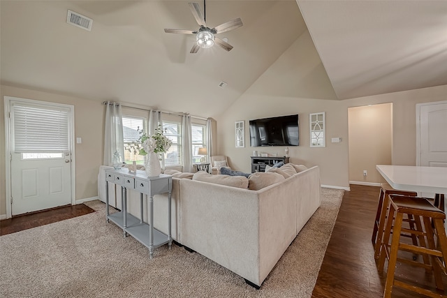 living room with dark wood-type flooring, ceiling fan, and high vaulted ceiling