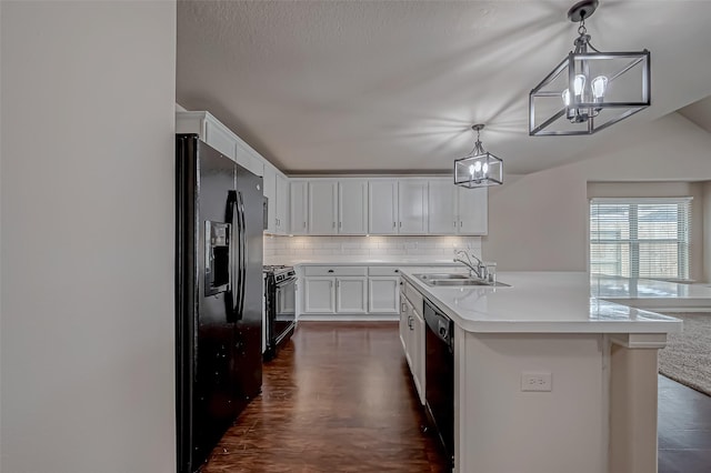 kitchen with a sink, white cabinets, light countertops, decorative backsplash, and black appliances