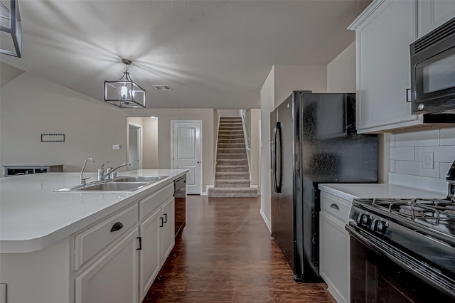 kitchen with a sink, white cabinetry, light countertops, decorative backsplash, and black appliances