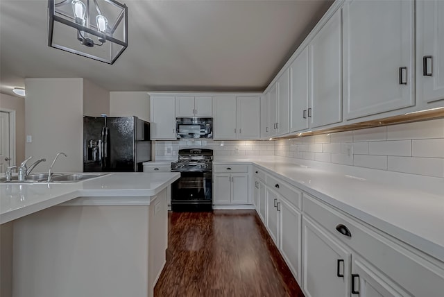 kitchen with dark wood-type flooring, a sink, black appliances, white cabinetry, and backsplash