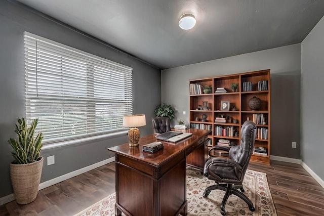 home office with baseboards and dark wood-style flooring