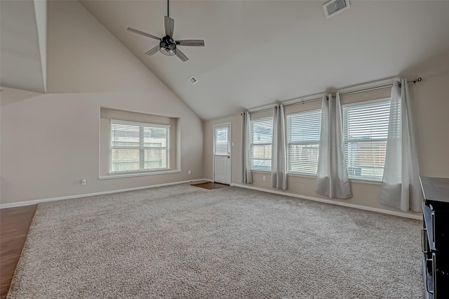 interior space featuring high vaulted ceiling, a wealth of natural light, visible vents, and baseboards