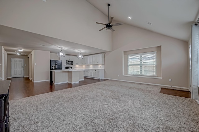 unfurnished living room with baseboards, ceiling fan, dark colored carpet, high vaulted ceiling, and recessed lighting