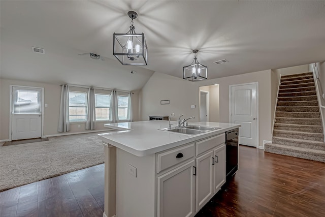 kitchen with black dishwasher, open floor plan, visible vents, and a sink