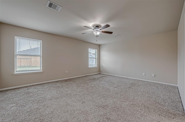 empty room featuring baseboards, carpet, visible vents, and a ceiling fan