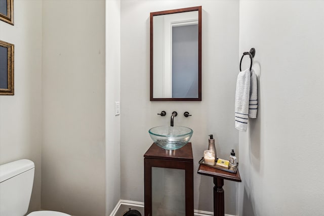 bathroom featuring toilet and vanity