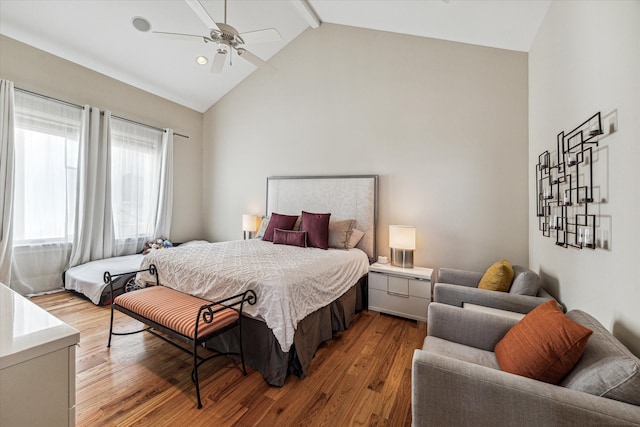 bedroom featuring high vaulted ceiling, hardwood / wood-style floors, ceiling fan, and beamed ceiling