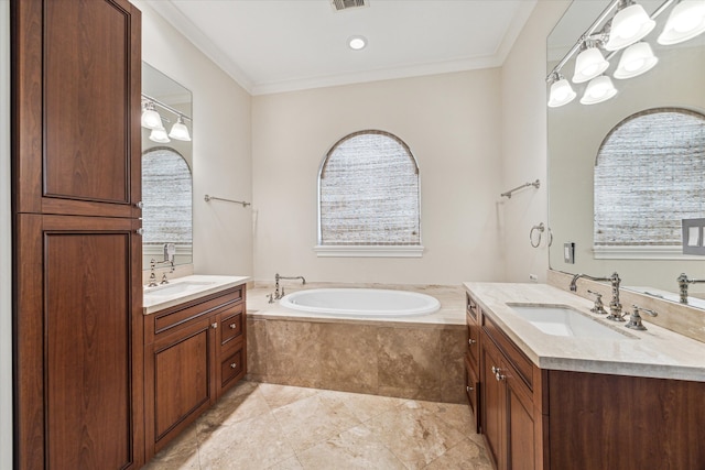 bathroom with tiled tub, vanity, and ornamental molding