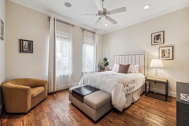 bedroom with ornamental molding, ceiling fan, and dark hardwood / wood-style floors