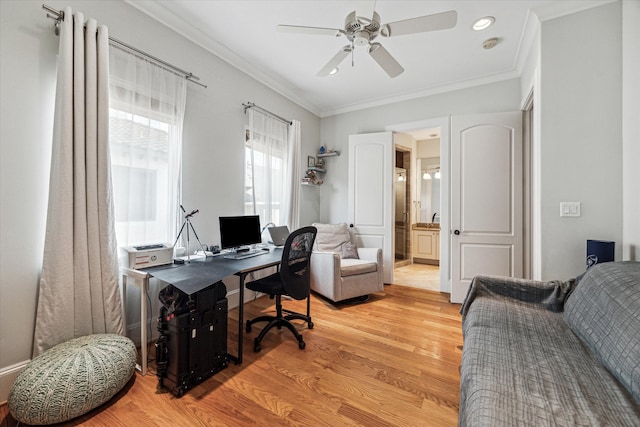 office space featuring crown molding, ceiling fan, and light wood-type flooring