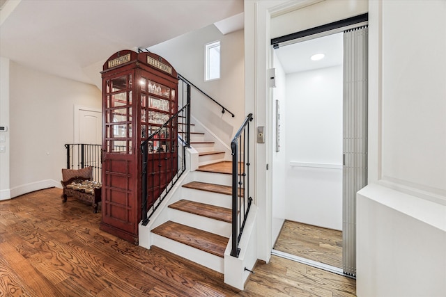 staircase featuring hardwood / wood-style flooring