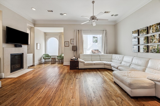 unfurnished living room with a healthy amount of sunlight, ceiling fan, dark hardwood / wood-style floors, and a tile fireplace