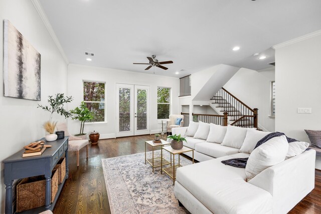 living room featuring dark hardwood / wood-style floors, ornamental molding, french doors, and ceiling fan