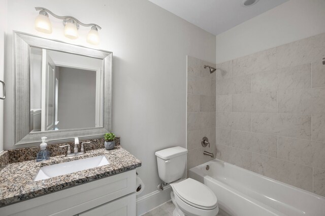 full bathroom featuring toilet, vanity, and tiled shower / bath