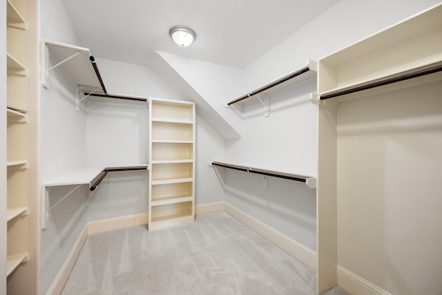 spacious closet featuring light carpet