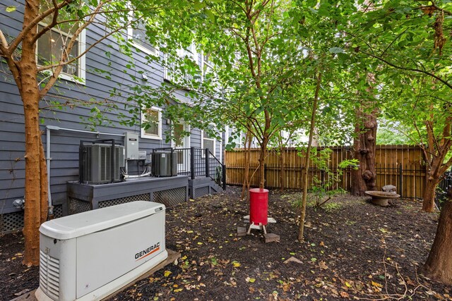 view of yard featuring a deck and central air condition unit