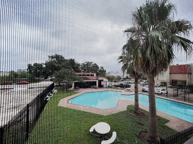 pool with fence and a patio