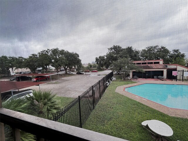 view of pool featuring a yard