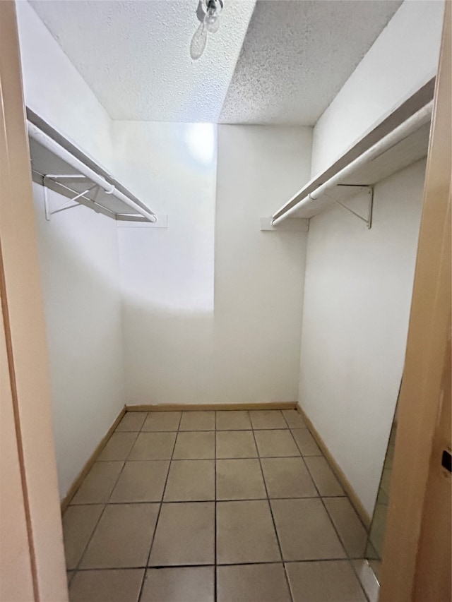 spacious closet with light tile patterned floors