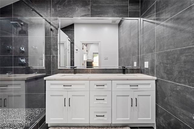 bathroom featuring vanity, tile walls, and walk in shower