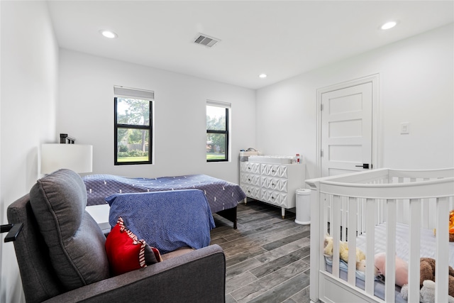 bedroom with dark wood-type flooring