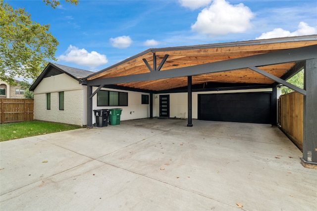 rear view of house featuring a garage and a carport