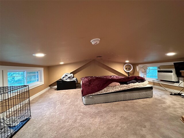 carpeted bedroom featuring lofted ceiling and multiple windows