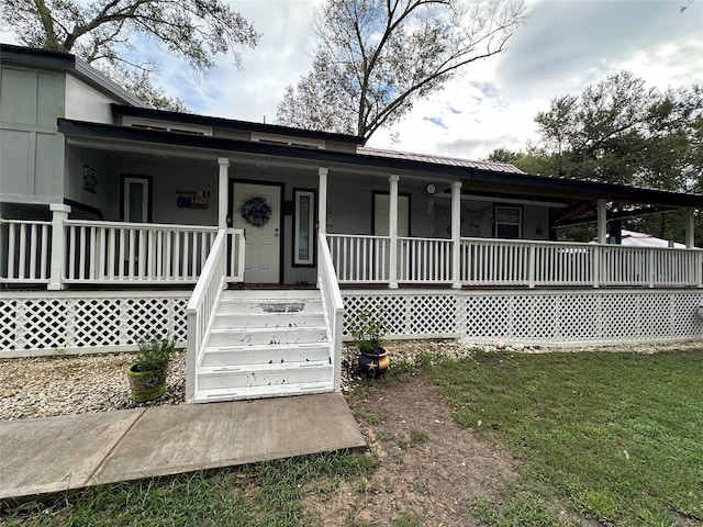 view of front of house with covered porch and metal roof