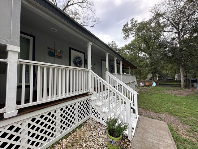 view of property exterior with a lawn and covered porch