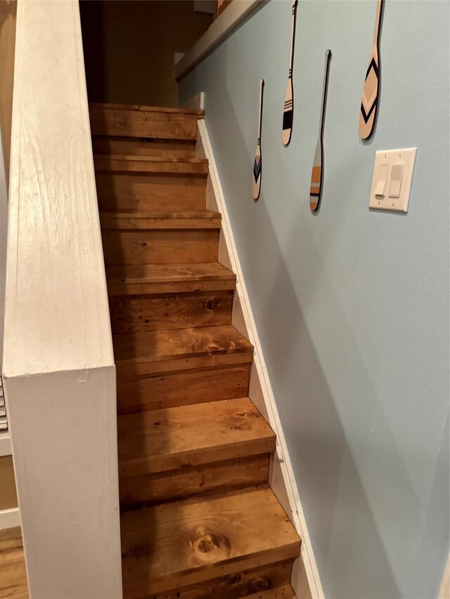 stairway with hardwood / wood-style floors