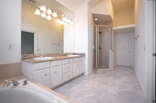 bathroom with vanity, high vaulted ceiling, and shower with separate bathtub