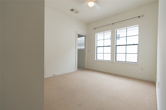 carpeted empty room featuring ceiling fan