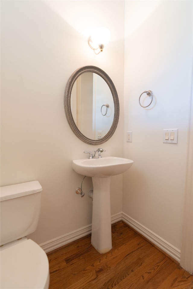 bathroom featuring toilet and hardwood / wood-style flooring