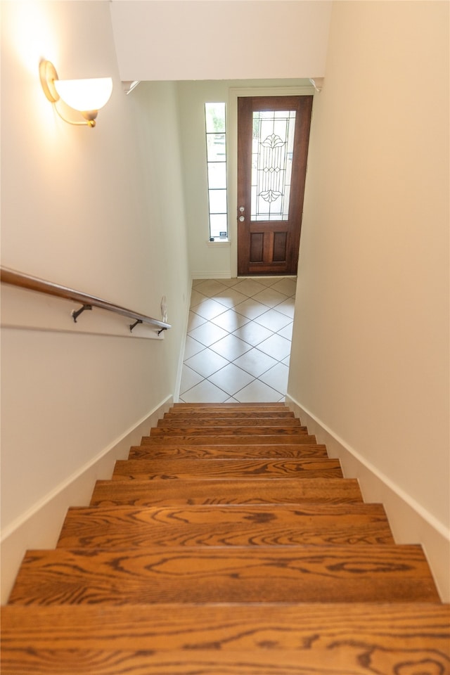 stairs featuring tile patterned floors